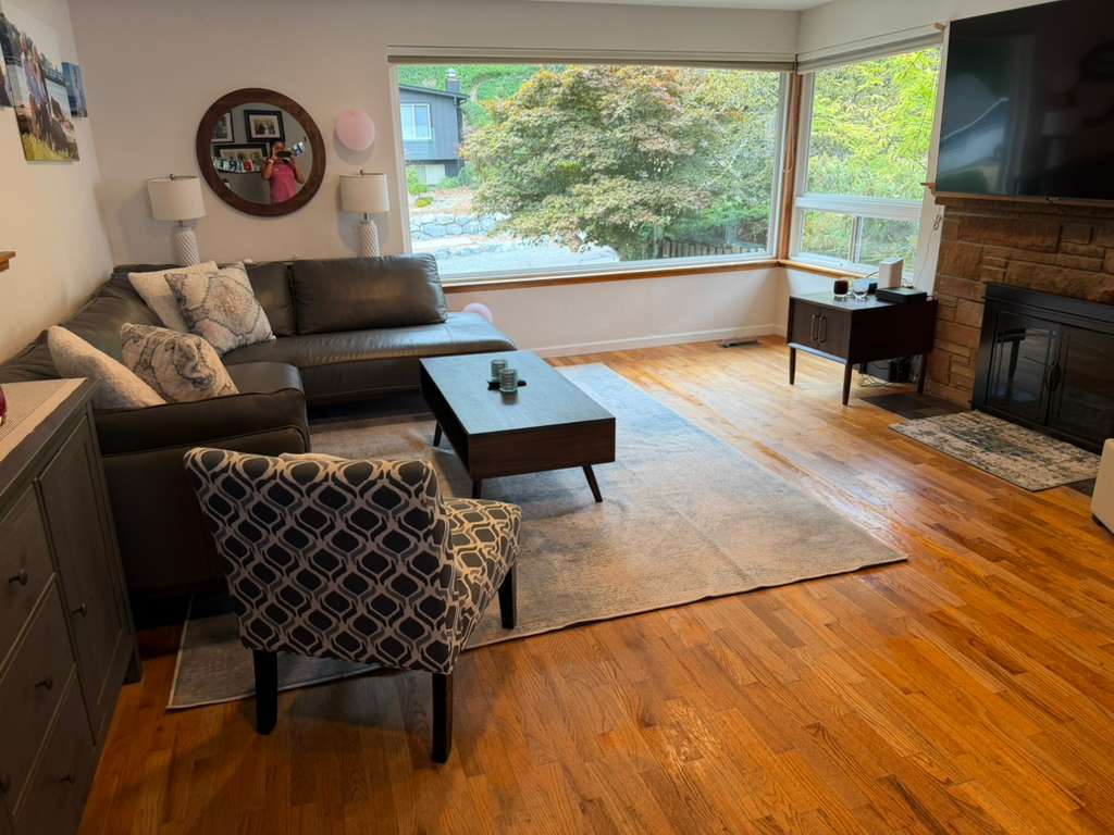 Clean, tidy condo living room with vacuumed rug and dusted surfaces